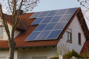 Rooftop,With,Solar,Panels,And,Yellow,Flowers,At,South,Germany